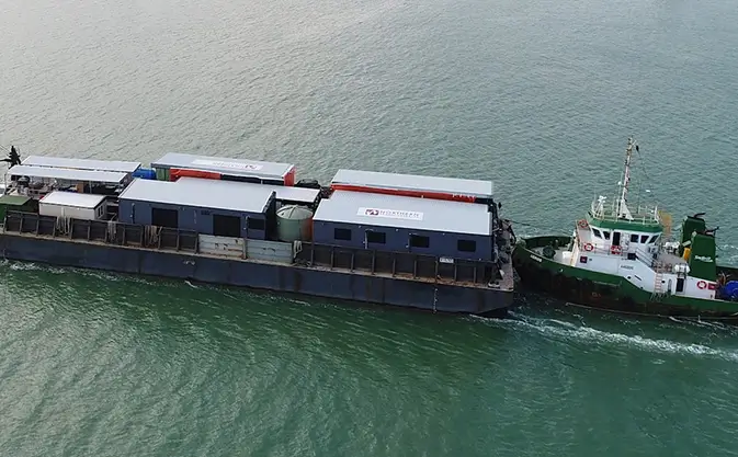 Barge transporting modular buildings.